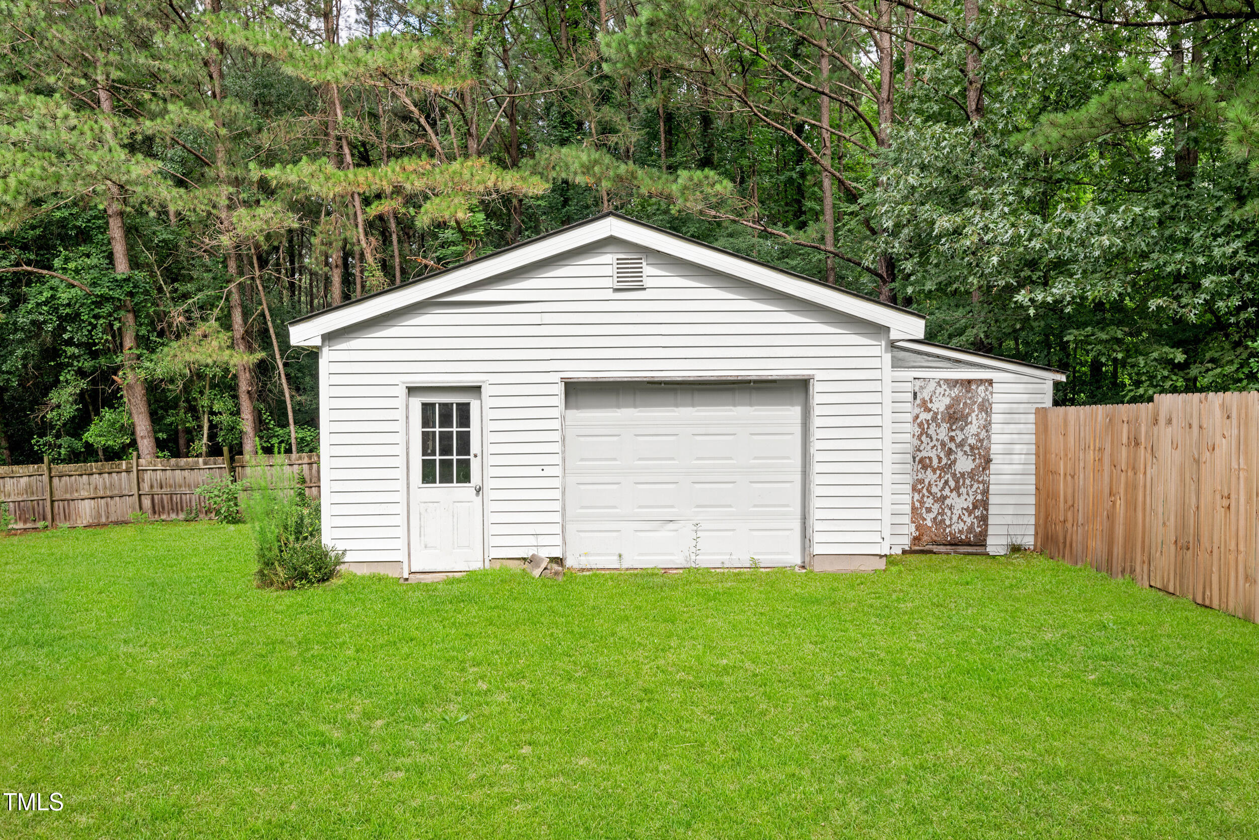 2430 Josephine Road Garner, NC 27529 - Photo 42 of 48 a front view of a house with a garden