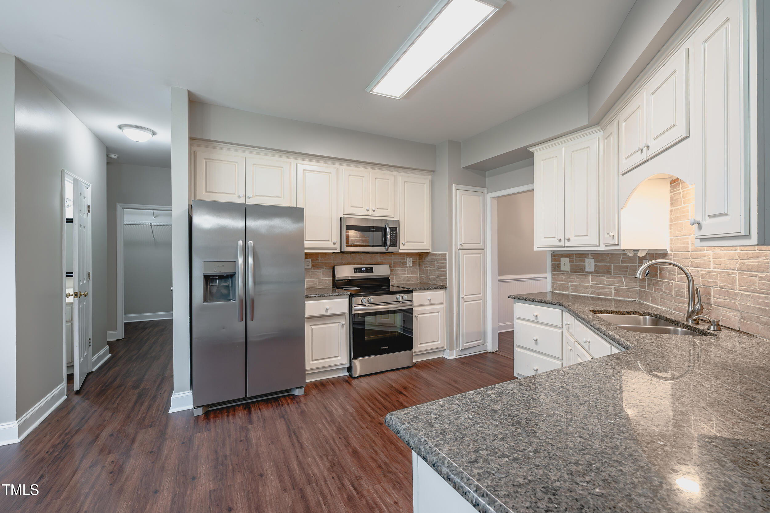 2430 Josephine Road Garner, NC 27529 - Photo 9 of 48 a kitchen with granite countertop a refrigerator and a sink