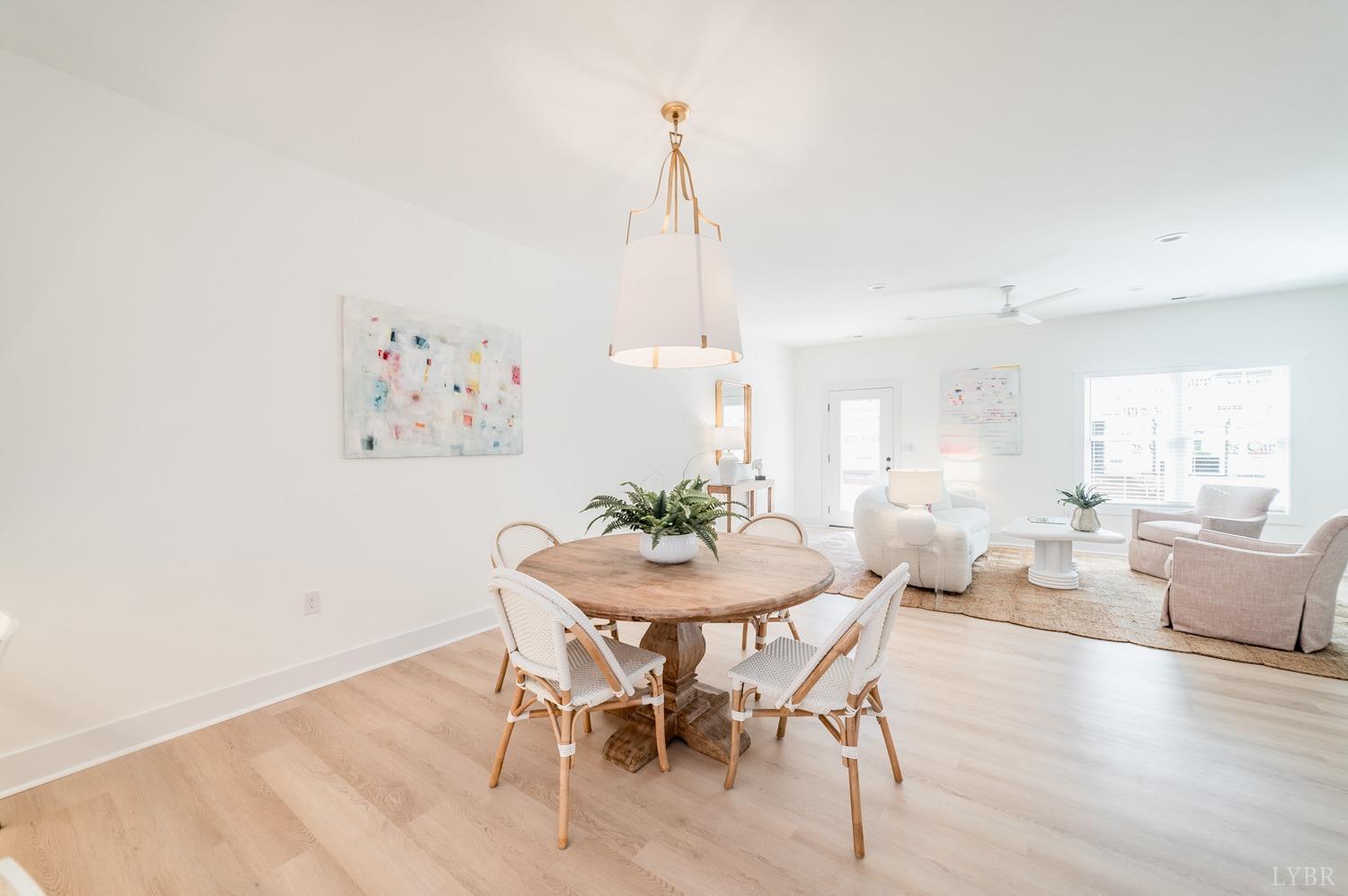556 Leesville Road, Unit 905 Lynchburg, VA 24502 - Photo 13 of 40 a dining room with furniture a chandelier and wooden floor