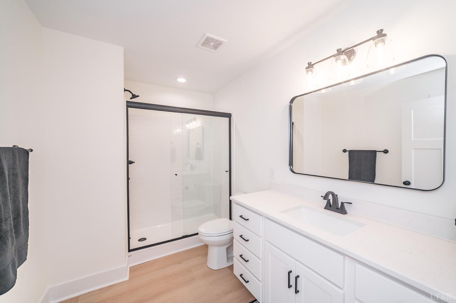 556 Leesville Road, Unit 905 Lynchburg, VA 24502 - Photo 25 of 40 a bathroom with a granite countertop sink mirror and toilet