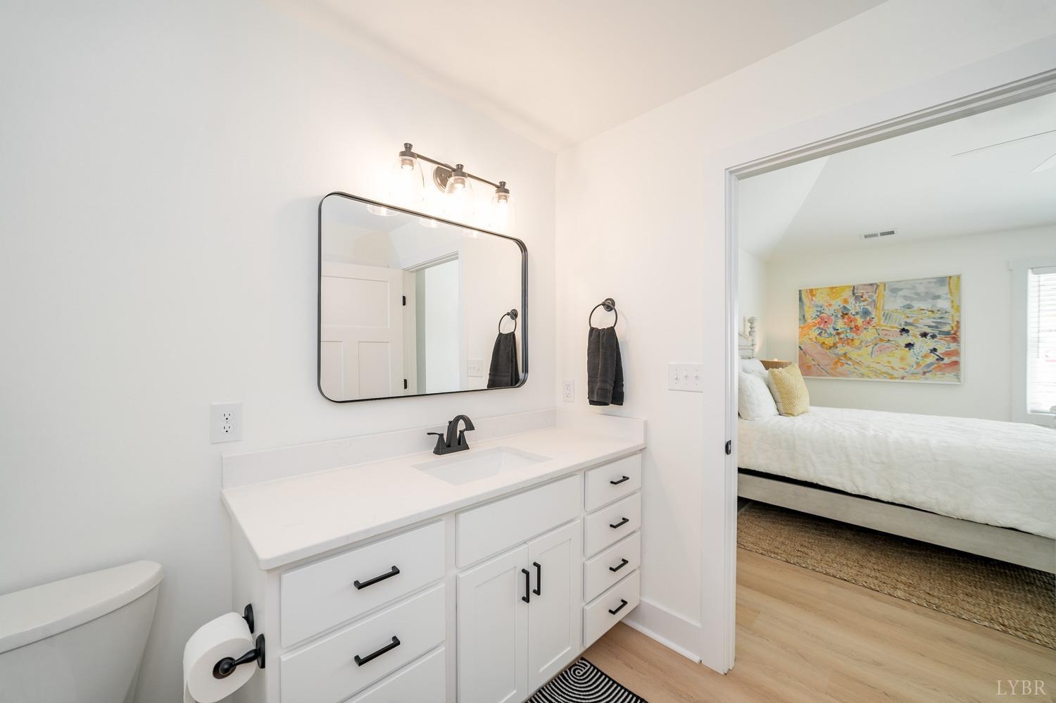 556 Leesville Road, Unit 905 Lynchburg, VA 24502 - Photo 26 of 40 a bathroom with a sink a toilet and a mirror