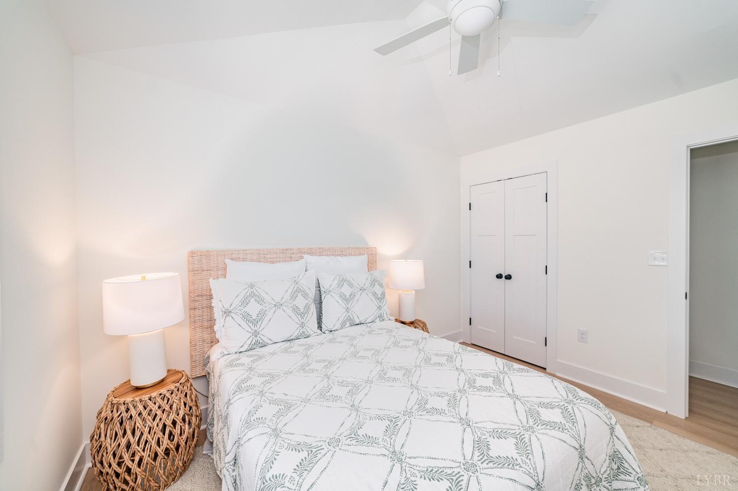556 Leesville Road, Unit 905 Lynchburg, VA 24502 - Photo 39 of 40 a bedroom with a bed and a lamp