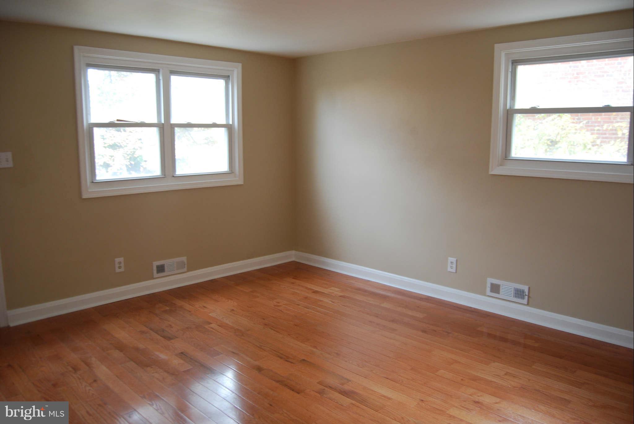1326 Halstead Road Parkville, MD 21234 - Photo 7 of 30 an empty room with wooden floor and windows