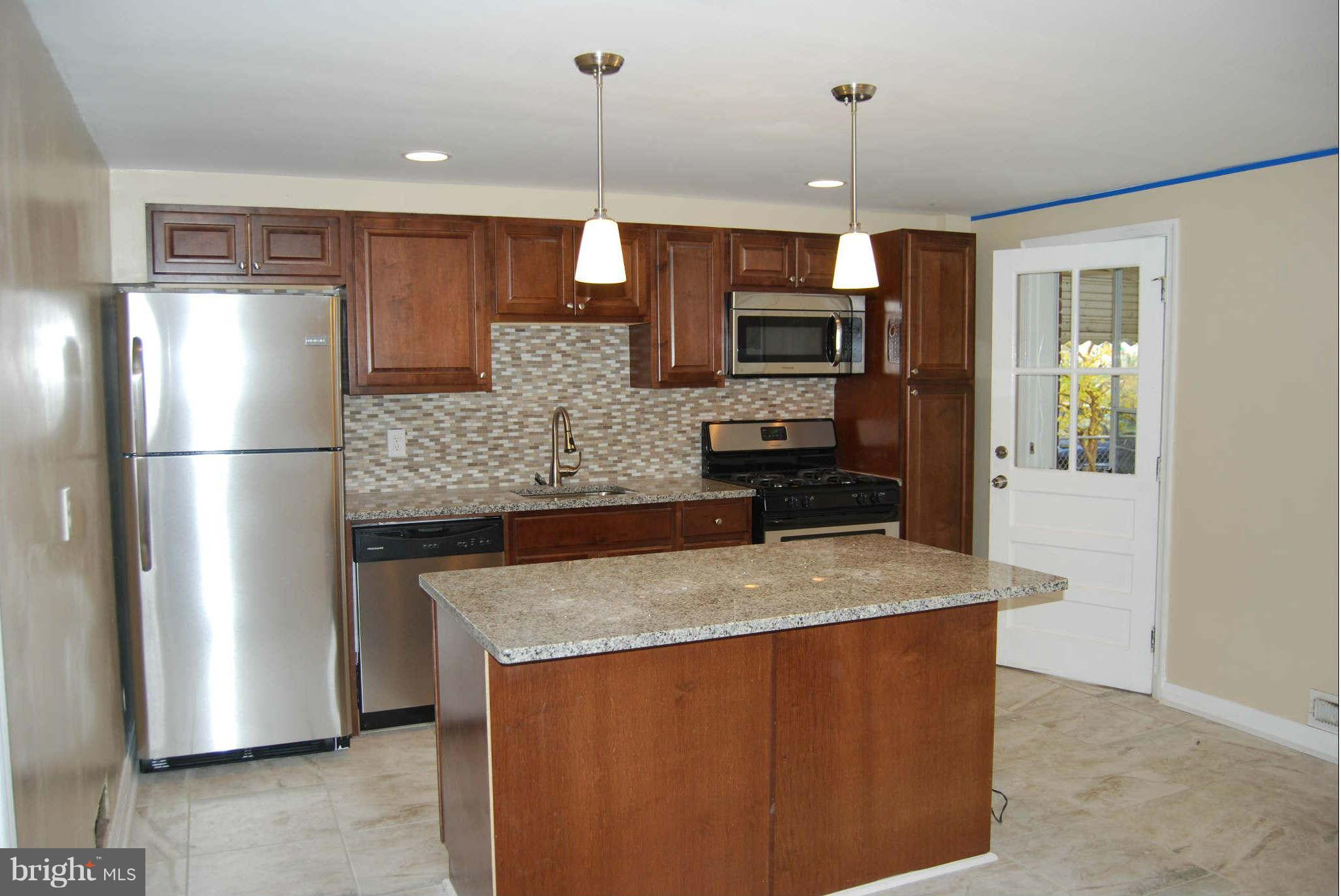 1326 Halstead Road Parkville, MD 21234 - Photo 8 of 30 a kitchen with stainless steel appliances granite countertop a refrigerator a stove and a sink