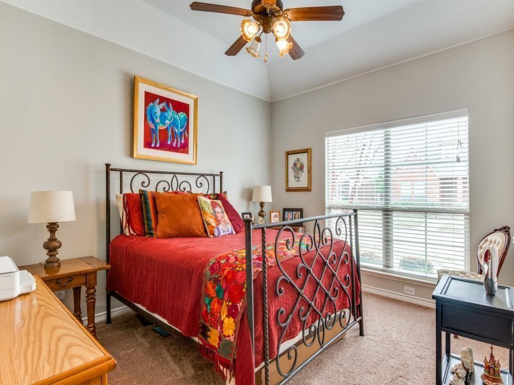 9962 Bell Rock Road Frisco, TX 75035 - Photo 20 of 28 a bedroom with a bed and a chandelier