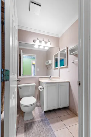 a spacious bathroom with a toilet sink and mirror