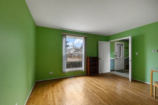 an empty room with closet and windows