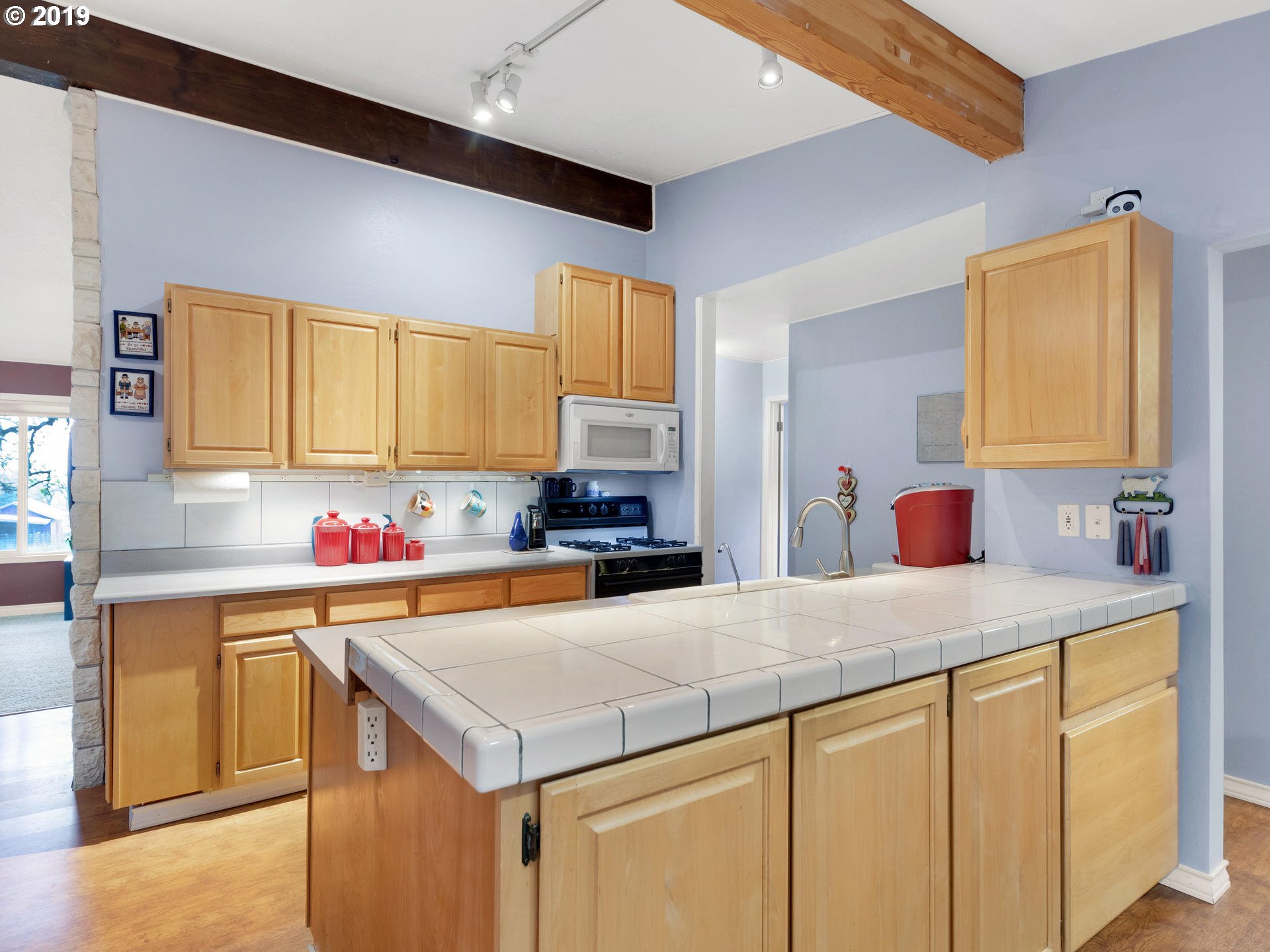 21390 Southwest Farmington Road Beaverton, OR 97007 - Photo 8 of 25 a kitchen with a sink a stove and cabinets