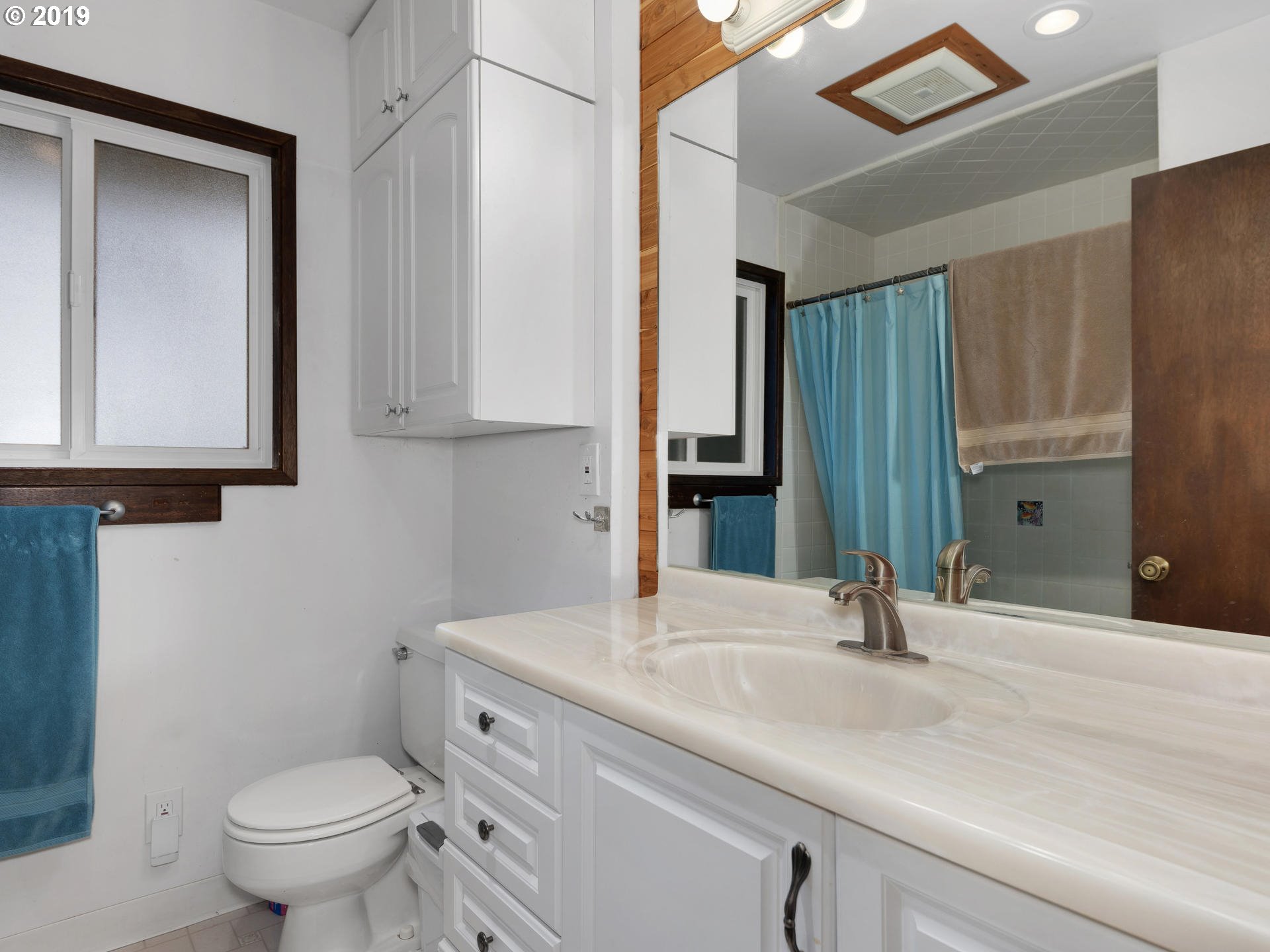 21390 Southwest Farmington Road Beaverton, OR 97007 - Photo 10 of 25 a bathroom with a toilet a sink and a mirror