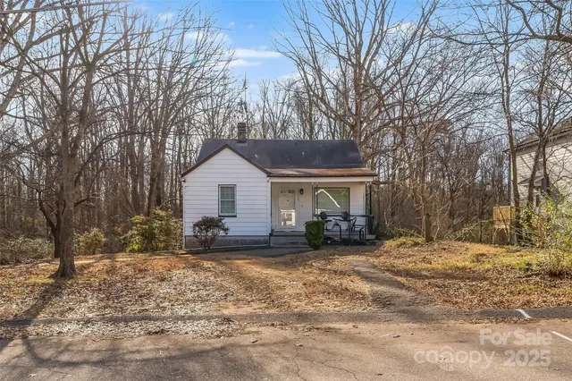 a view of a house with a yard covered in snow