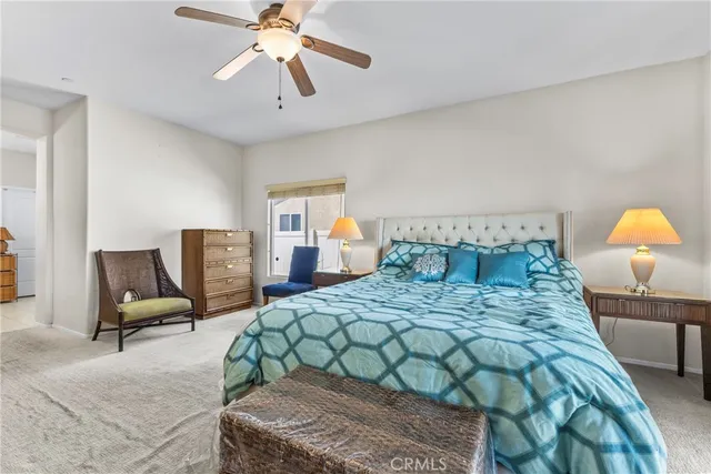 a bedroom with a bed a couch and dresser