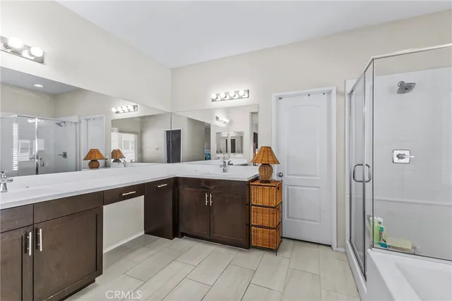 a large kitchen with a sink and dishwasher a refrigerator with wooden cabinets