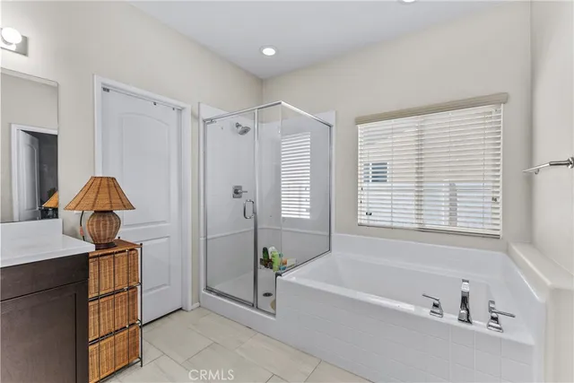 a bathroom with a tub shower and sink