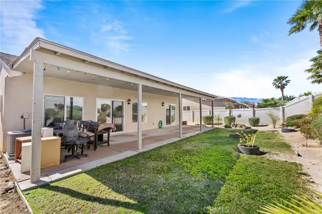 a view of a house with backyard porch and sitting area