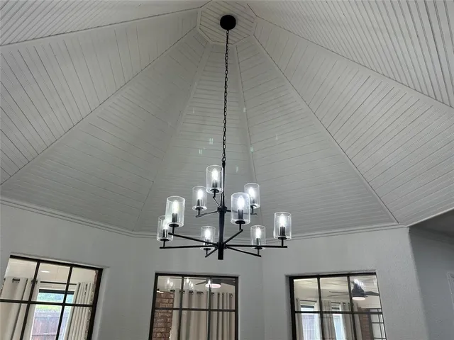 a view of a dining room with furniture wooden floor and chandelier
