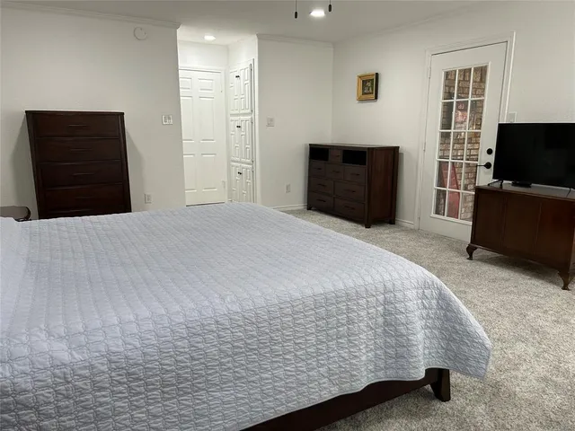 a bedroom with a bed and a television