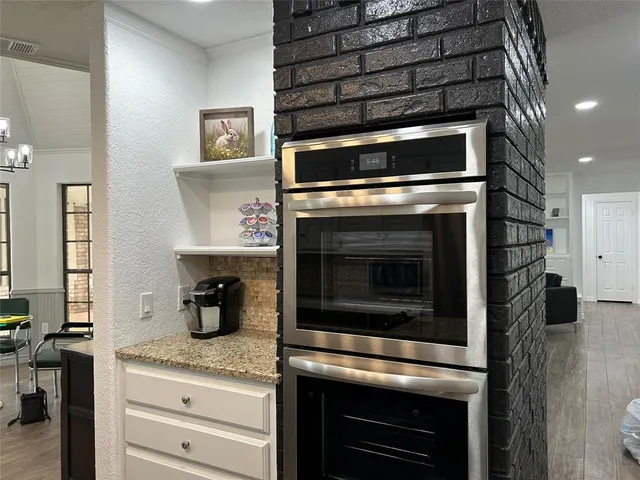a kitchen with granite countertop stainless steel appliances and cabinets