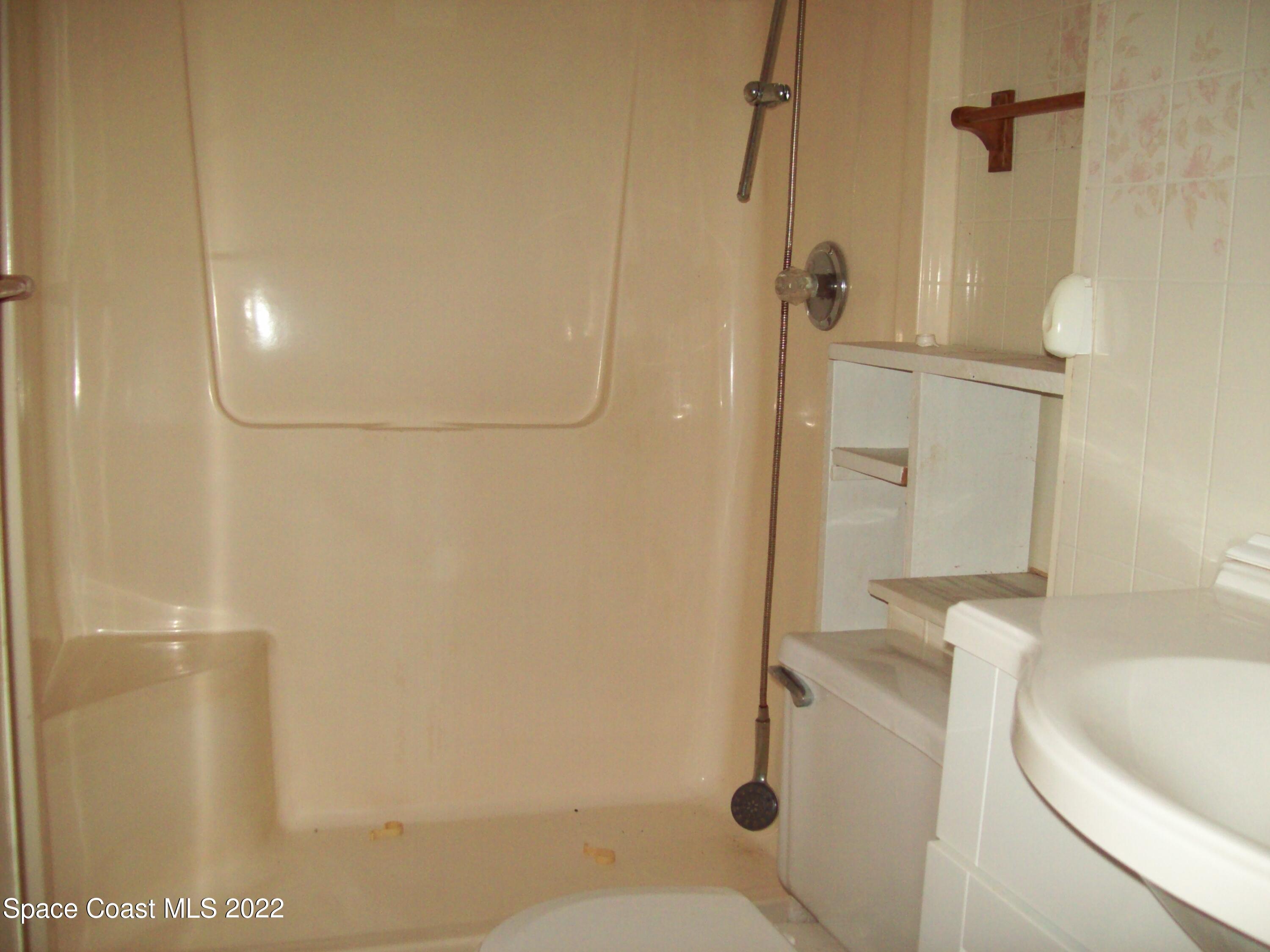 2224 Iowa Street Melbourne, FL 32904 - Photo 15 of 19 a bathroom with a sink and toilet