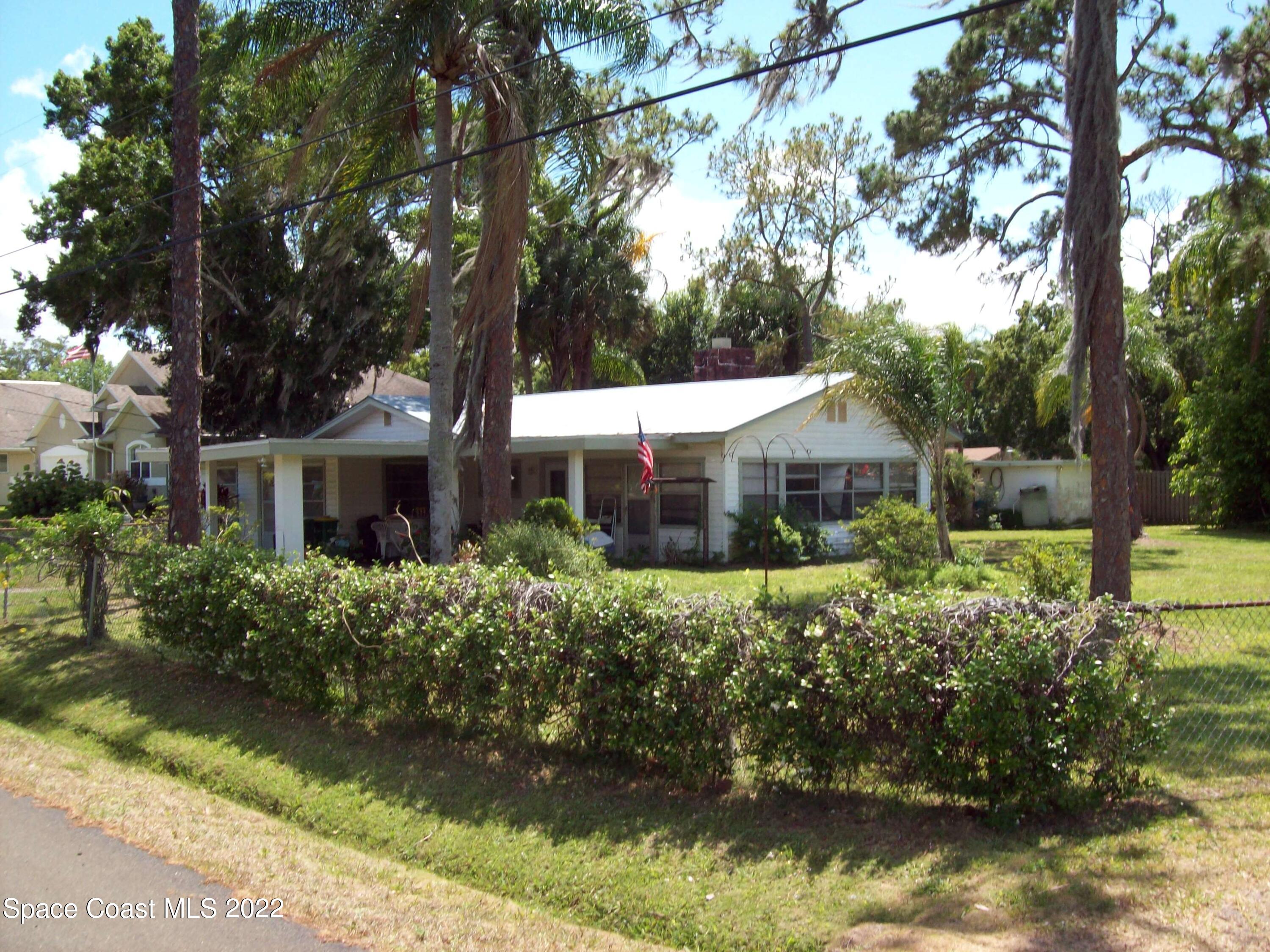 2224 Iowa Street Melbourne, FL 32904 - Photo 2 of 19 a front view of a house with a yard and lake view