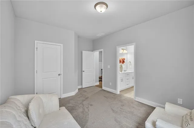 a view of a livingroom with furniture and bathroom