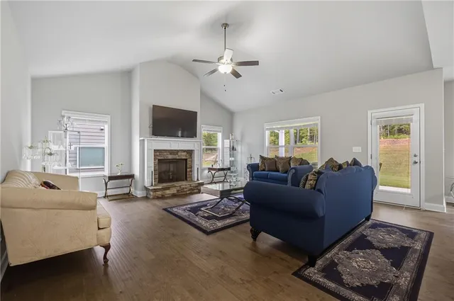 a living room with furniture a flat screen tv and a fireplace