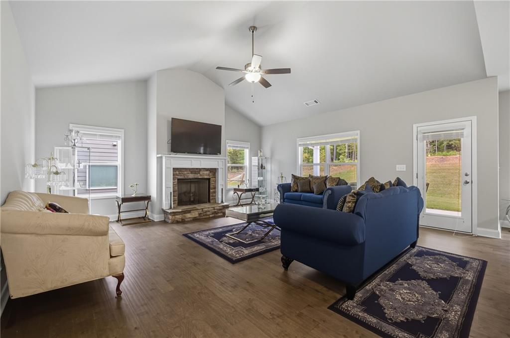 8325 Loch Lomand Lane Winston, GA 30187 - Photo 14 of 31 a living room with furniture a flat screen tv and a fireplace