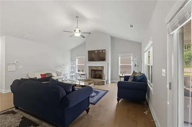 a living room with furniture a fireplace and a flat screen tv