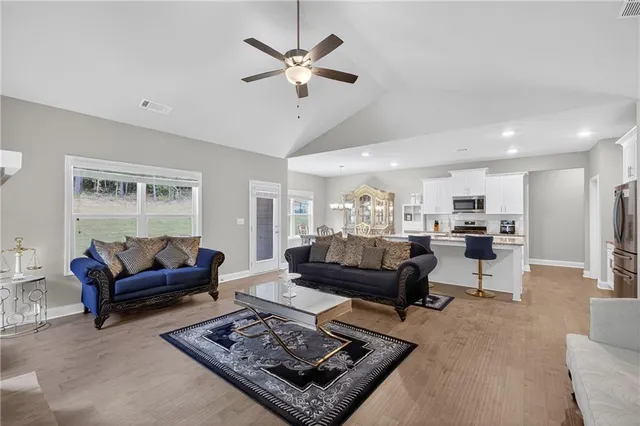 a living room with furniture a rug and a window
