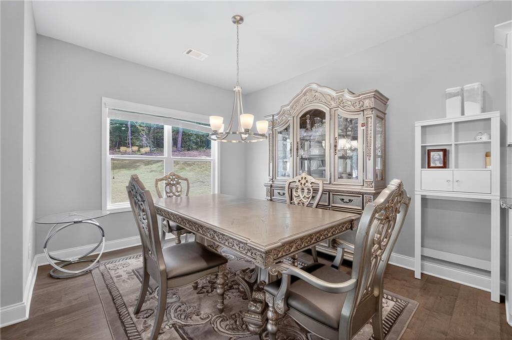 8325 Loch Lomand Lane Winston, GA 30187 - Photo 21 of 31 a view of a dining room with furniture and a chandelier