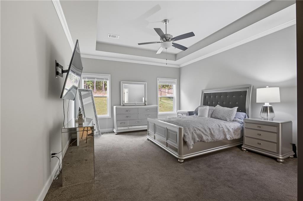 8325 Loch Lomand Lane Winston, GA 30187 - Photo 24 of 31 a bedroom with a bed and a chandelier