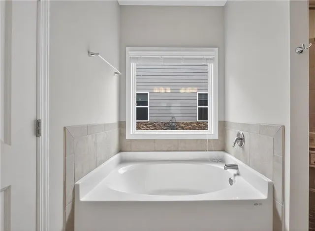 a white bath tub sitting next to a window