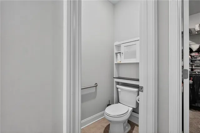 a bathroom with a granite countertop toilet and a sink