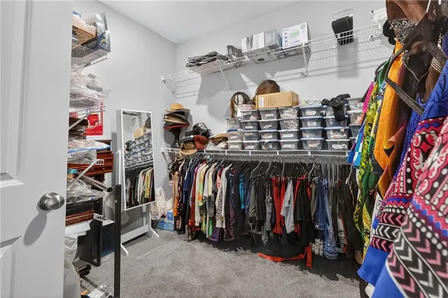 a view of walk in closet with clothes