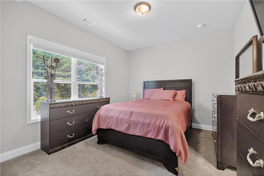 8325 Loch Lomand Lane Winston, GA 30187 - Photo 7 of 31 a bedroom with a bed and a window