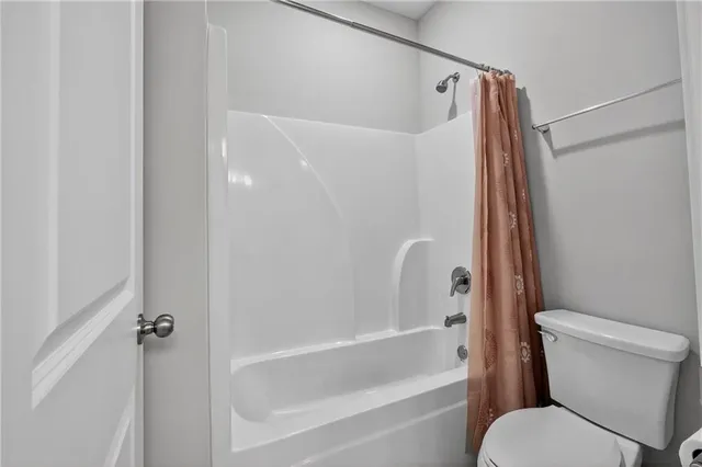 a bathroom with a toilet and a bathtub