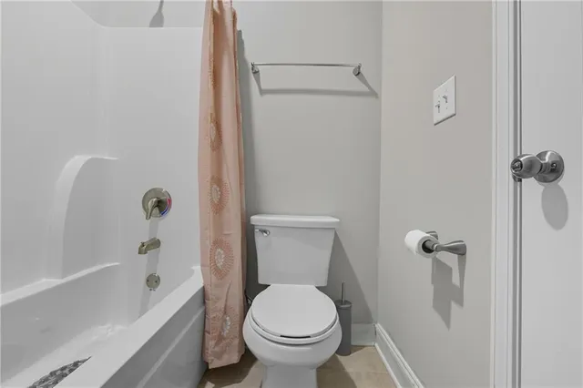 a bathroom with a toilet and a tub