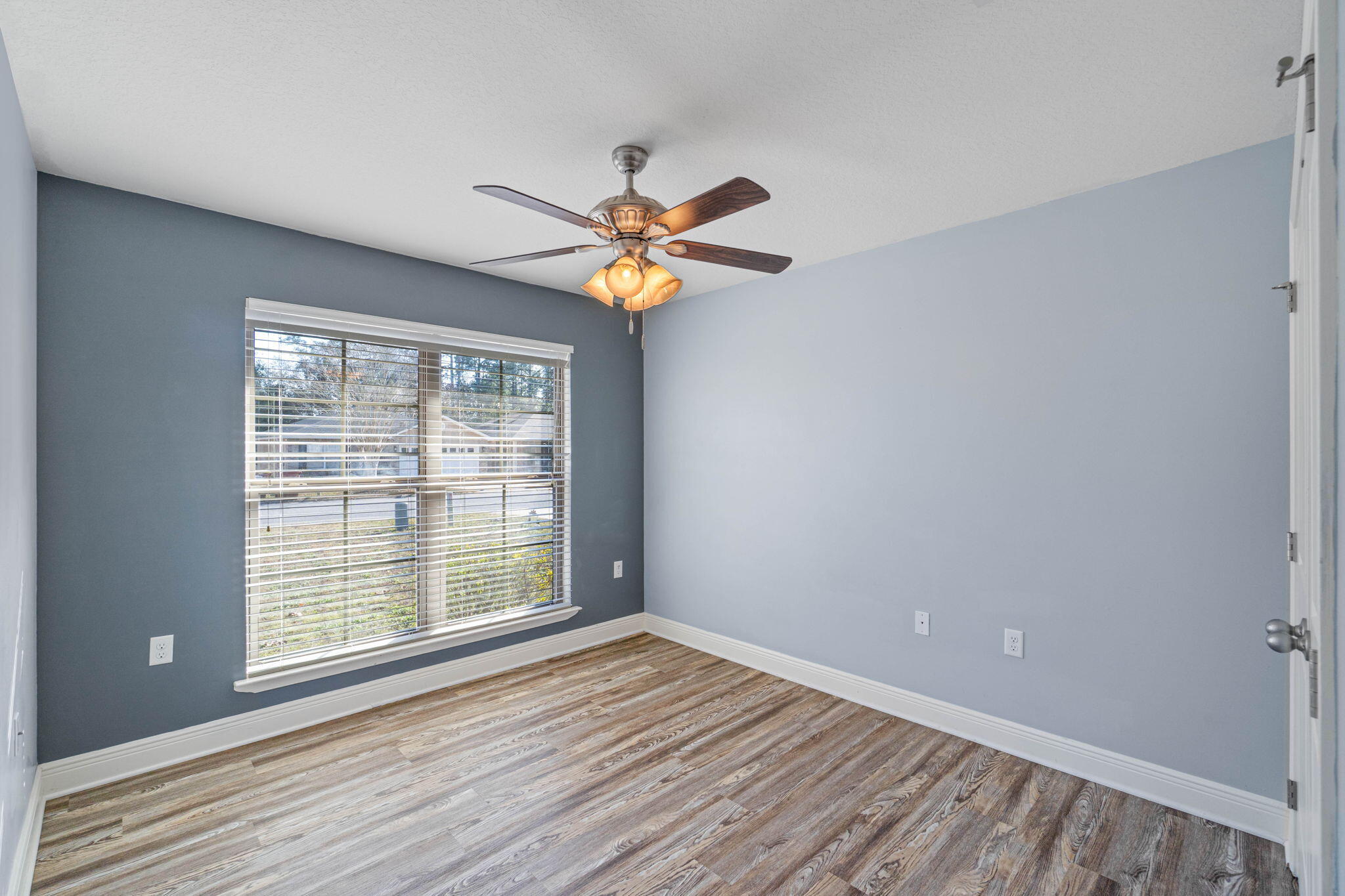 227 January Court Crestview, FL 32539 - Photo 13 of 25 a view of an empty room with window and wooden floor