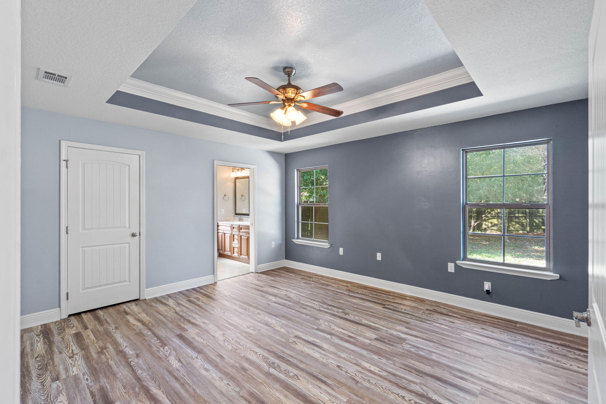227 January Court Crestview, FL 32539 - Photo 17 of 25 a view of an empty room with window and wooden floor