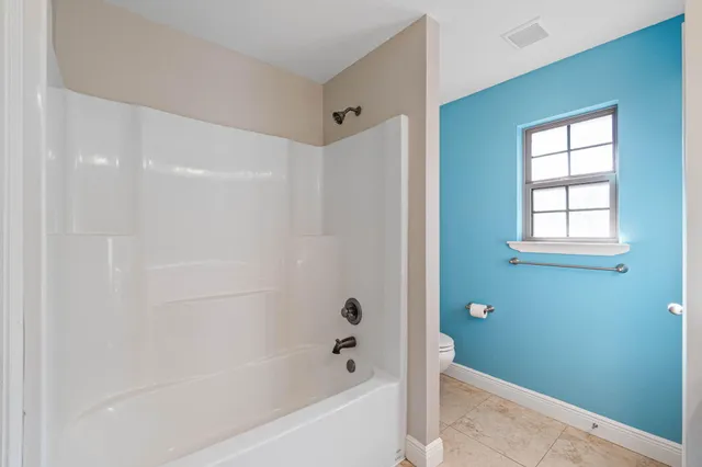 a bathroom with a bathtub and shower