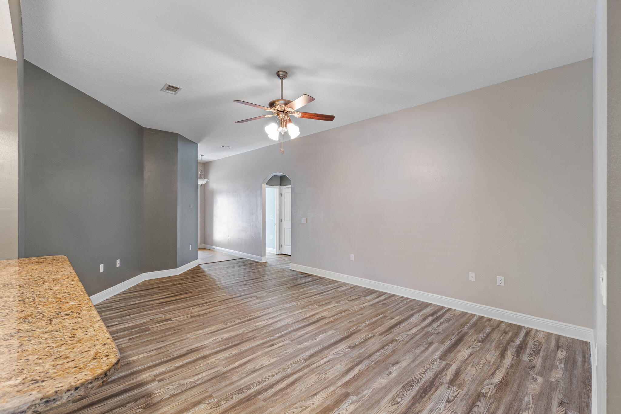 227 January Court Crestview, FL 32539 - Photo 4 of 25 wooden floor in an empty room with a window