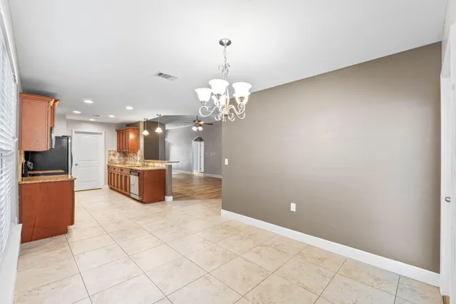 a view of a kitchen with a sink and a chandelier