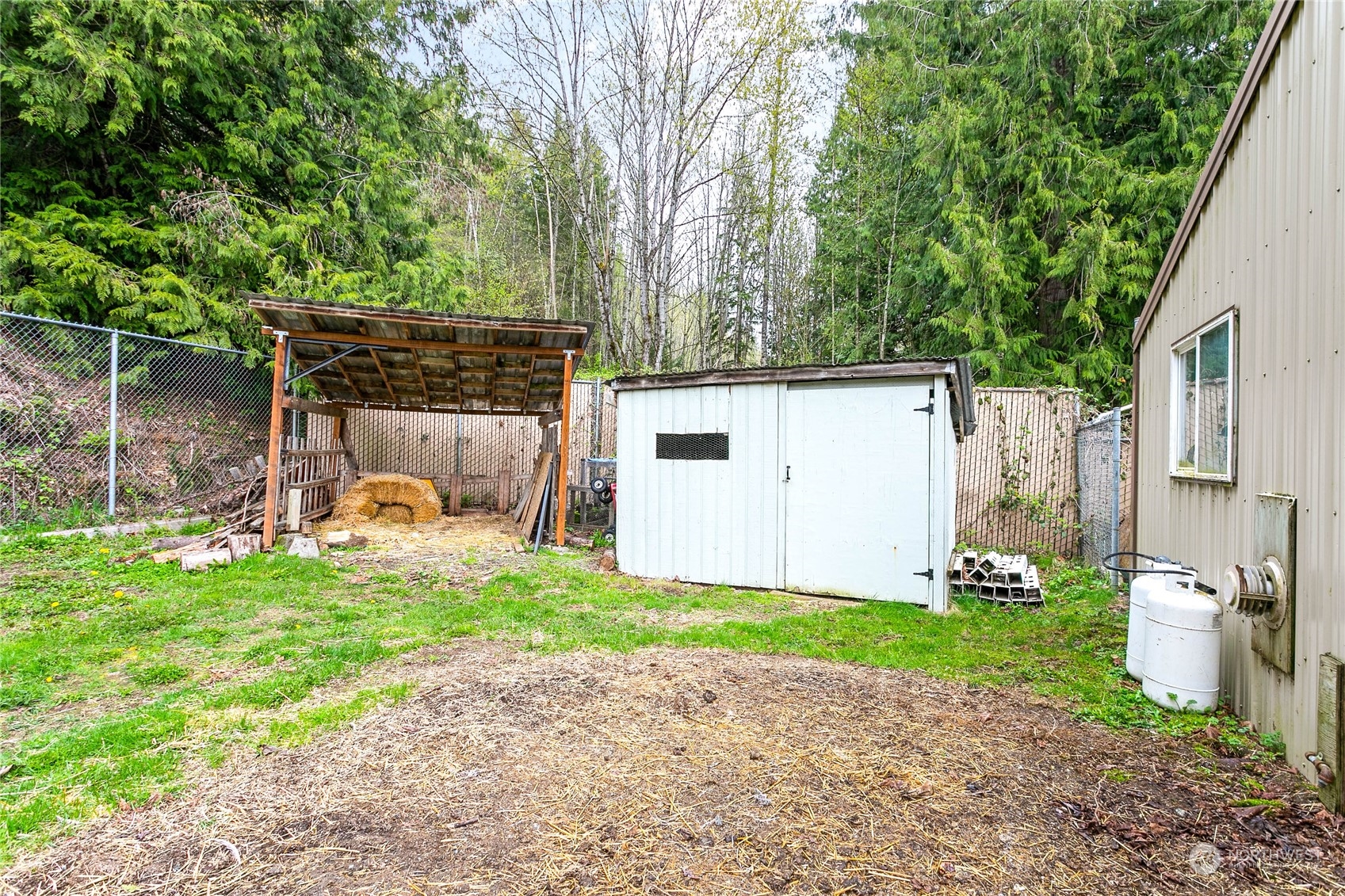 6040 Reese Hill Road Sumas, WA 98295 - Photo 32 of 34 a view of a chair and table in backyard of the house