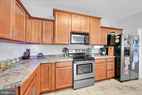 a kitchen that has a sink and a stove in it