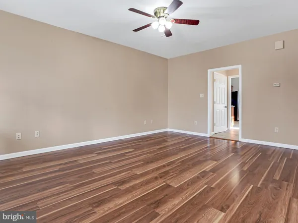 a living room with furniture a rug and a bookshelf