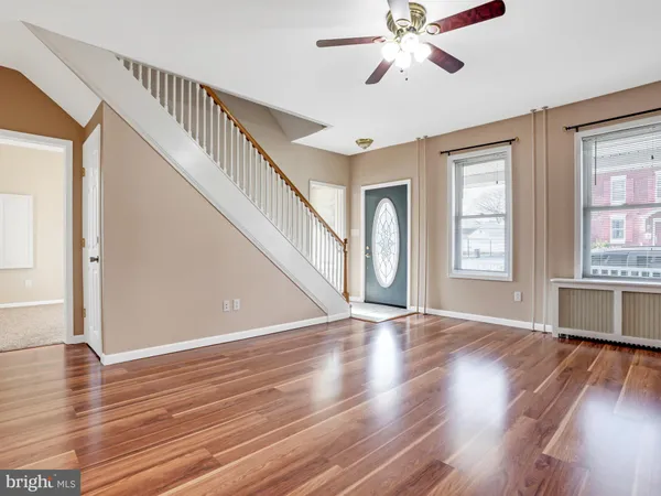 a living room with table chairs and a large window