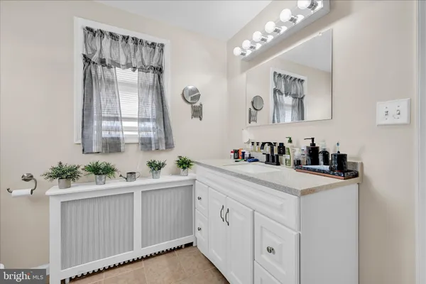 an empty room with windows and chandelier fan