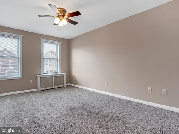 a bedroom with a bed and a ceiling fan