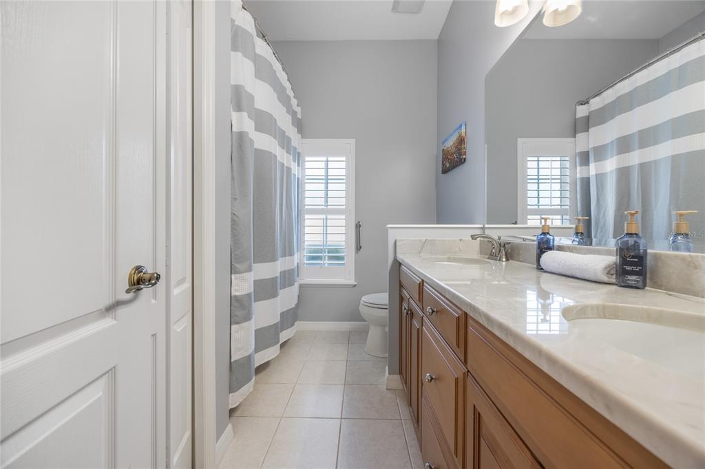 7146 Southwest 35th Avenue Gainesville, FL 32608 - Photo 54 of 83 a bathroom with a granite countertop sink mirror and a toilet