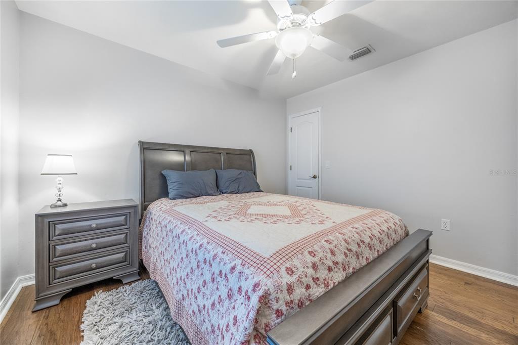 7146 Southwest 35th Avenue Gainesville, FL 32608 - Photo 57 of 83 a bedroom with a bed and a chandelier