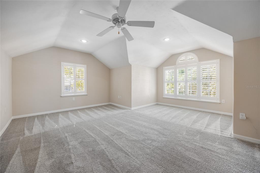 7146 Southwest 35th Avenue Gainesville, FL 32608 - Photo 60 of 83 an empty room with windows and ceiling fan